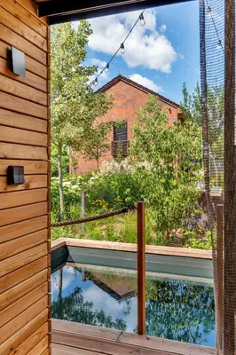 a view of a pool from the outside of a house at Apartmán Rezidence Malá Louka in Kublov