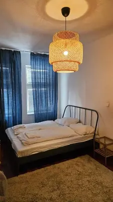 a bedroom with a bed and a chandelier at Zizkov Apartment in Prague