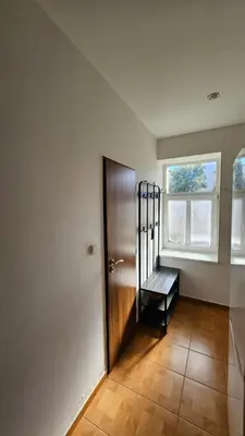 an empty hallway with a door and a window at Zizkov Apartment in Prague