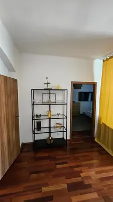 a room with a shelf with a cross and a door at Zizkov Apartment in Prague