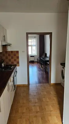 a kitchen and dining room with a dining table and a kitchen at Zizkov Apartment in Prague