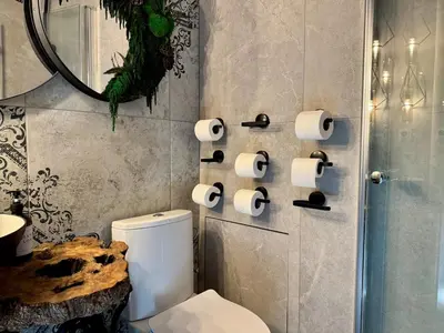 a bathroom with a toilet and rolls of toilet paper at Garden Residence - The Garage in Drahobudice