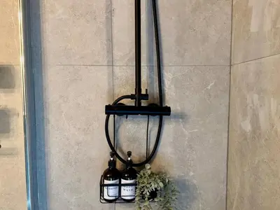 a group of wine bottles hanging on a wall at Garden Residence - The Garage in Drahobudice