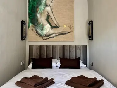a bedroom with a bed with two towels on it at Garden Residence - The Garage in Drahobudice