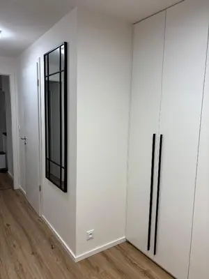 a room with white cabinets and a mirror at Apartment Vyšehrad in Prague