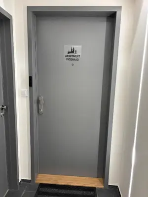 a door with a sign on it in a hallway at Apartment Vyšehrad in Prague