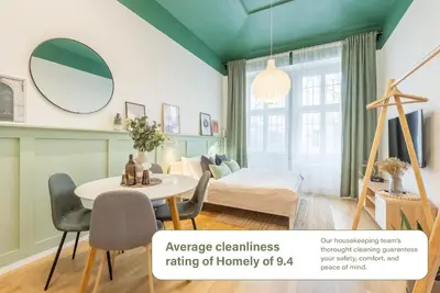 a room with a bed and a table and chairs at HOMELY I Central 28m2 loft I ELEVATOR I Self Check-In in Prague