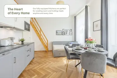 a kitchen and dining room with a table and chairs at HOMELY I Central 28m2 loft I ELEVATOR I Self Check-In in Prague