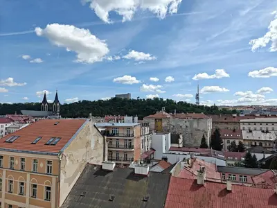 a view of a city with roofs and buildings at Penthouse With City Terrace in Prague