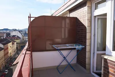 a balcony with a table on the side of a building at Penthouse With City Terrace in Prague