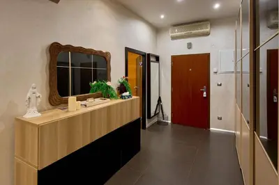 a bathroom with a sink and a mirror and a door at Heart of Prague Stylish 3BR Apartment in Prague