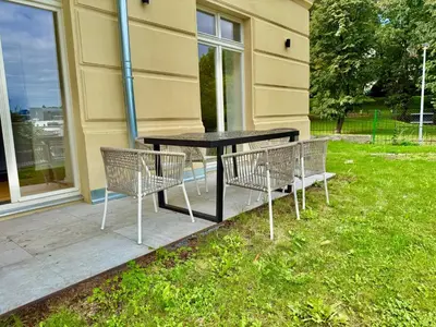 a black table and two chairs on a patio at Modern Luxury Apartment with Garden in Prague