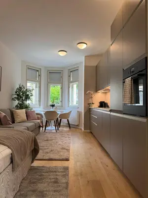a living room with a couch and a table at Modern Luxury Apartment with Garden in Prague