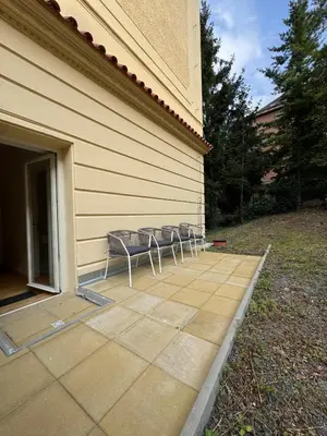 a group of chairs sitting on a patio at Modern Luxury Apartment with Garden in Prague