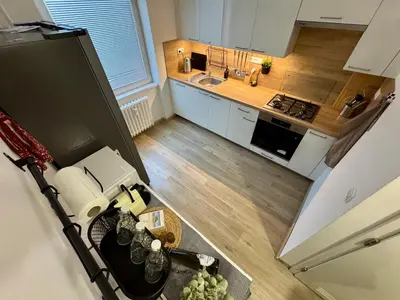 an overhead view of a small kitchen with a refrigerator at FH Apartment Letňany in Prague