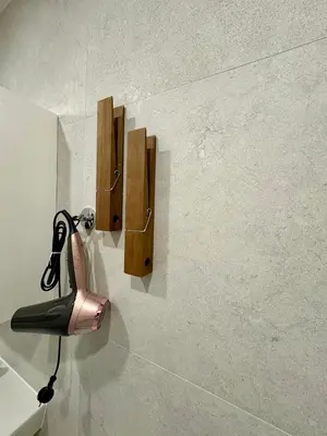 a blow dryer hanging on a wall in a bathroom at FH Apartment Letňany in Prague