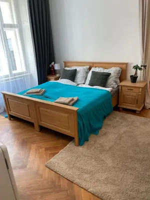 a bedroom with a large bed with blue sheets and pillows at štepánská noc B in Prague