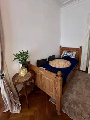 a bedroom with a bed and a table with a plant at štepánská noc B in Prague