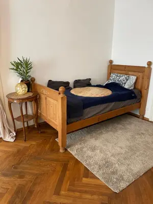 a bedroom with a wooden bed and a table at štepánská noc B in Prague
