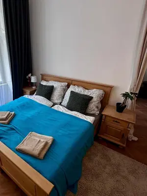 a bedroom with a bed with blue sheets and pillows at štepánská noc B in Prague