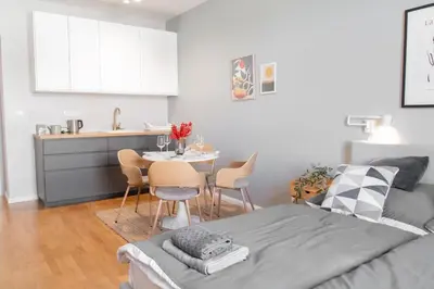 a bedroom with a bed and a kitchen with a table at Apartment in Prague near Wenceslas Square in Prague