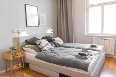 two beds in a bedroom with a window at Apartment in Prague near Wenceslas Square in Prague