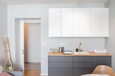 a kitchen with a sink and white cabinets at Apartment in Prague near Wenceslas Square in Prague