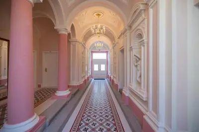an empty hallway with pink columns and a door at Apartment in Prague near Wenceslas Square in Prague