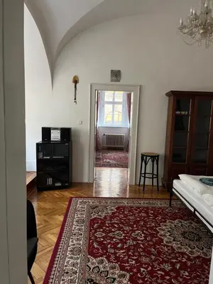 a living room with a red rug on the floor at Apartmán LACRON Praha in Prague