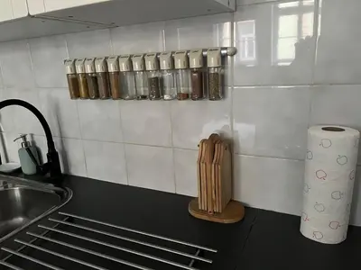 a kitchen with a counter with a sink and a knife block at Apartmán LACRON Praha in Prague