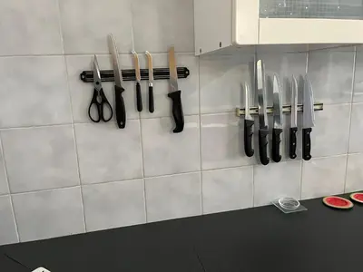 a bunch of knives hanging on a wall at Apartmán LACRON Praha in Prague