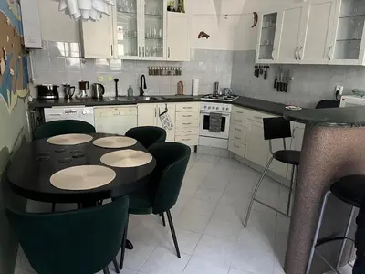 a kitchen with a black table and chairs in it at Apartmán LACRON Praha in Prague