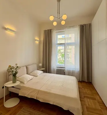 a bedroom with a large bed and a window at Old Soul,New Style,Best location in Prague