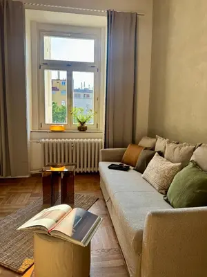 a living room with a couch and a window at Old Soul,New Style,Best location in Prague