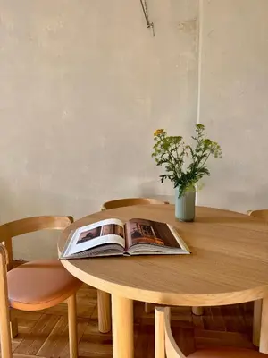 a book on a wooden table with a vase on it at Old Soul,New Style,Best location in Prague
