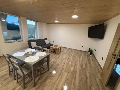 a living room with a table and a couch at House in Čakovice near Štětí in Štětí