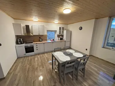 a kitchen and dining room with a table and chairs at House in Čakovice near Štětí in Štětí