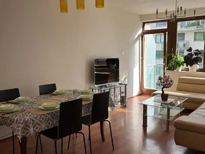 a living room with a table and chairs and a couch at Đã Về - Đã Tới 2 in Prague