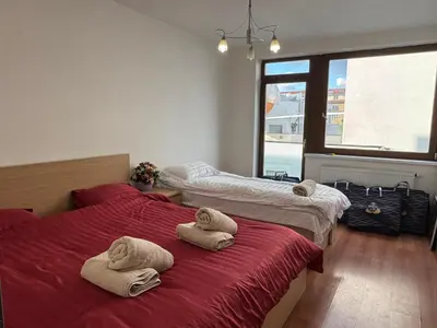 two beds with towels on them in a room at Đã Về - Đã Tới 2 in Prague