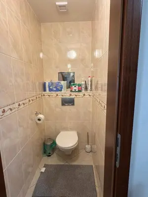 a bathroom with a toilet in a tiled room at Đã Về - Đã Tới 2 in Prague