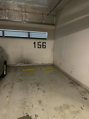 an empty garage with a car parked in it at Đã Về - Đã Tới 2 in Prague
