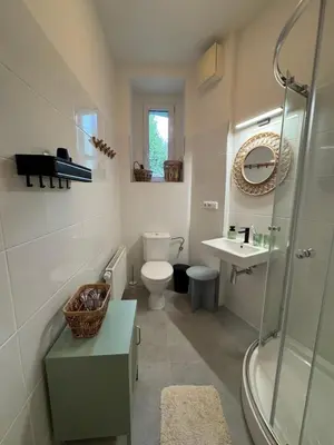 a bathroom with a toilet and a sink and a shower at Prague Apartment Tomani in Prague