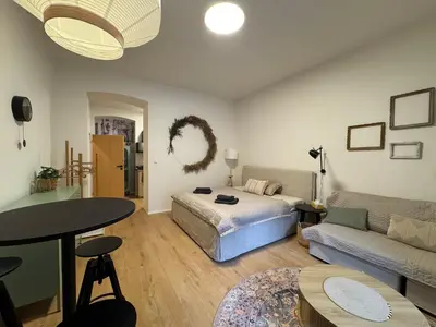 a living room with a bed and a couch at Prague Apartment Tomani in Prague