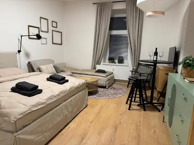 a bedroom with a bed and a living room at Prague Apartment Tomani in Prague