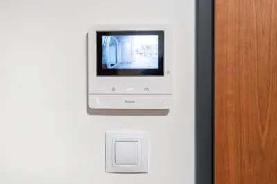 a computer monitor is mounted on a wall at Rentero Modern Prague Smichov Apartment with Balcony in Prague