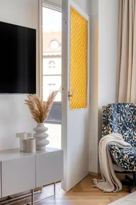 a bedroom with a bed and a table and a stool at Boutique Apartment - 2 Double Beds and Balcony in City Centre by Gravity Prague in Prague