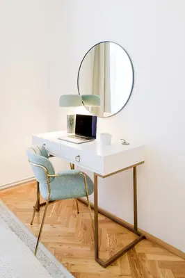 a desk with a mirror and a chair with a laptop at Prague Days - Apartments with AC in Vinohrady in Prague