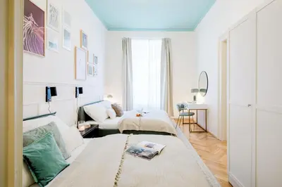 a living room with two beds and a couch at Prague Days - Apartments with AC in Vinohrady in Prague