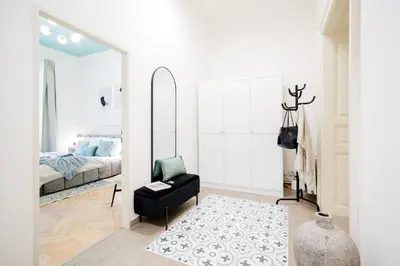 a bedroom with a bed and a mirror at Prague Days - Apartments with AC in Vinohrady in Prague