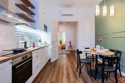 a kitchen with a table and chairs and a dining room at Prague Days - Apartments with AC in Vinohrady in Prague